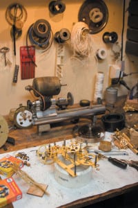 Shining brass internals of Howell Rust’s latest project sit in his workshop. Rust uses his grandfather’s tools when repairing clocks.