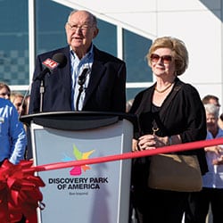 Robert and Jenny Kirkland address the crowd at the ribbon-cutting of Discovery Park of America. Below, the Discovery Center is a 100,000-square-foot facility with fun and educational exhibits throughout its many galleries.