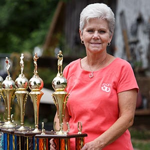 Joan Elmore proudly displays her six world championship trophies.