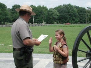 National Park Ranger Jim Lewis swears in a Junior Ranger at Stones River National Military Park in Murfreesboro. Photograph Courtesy of the National Park Service.