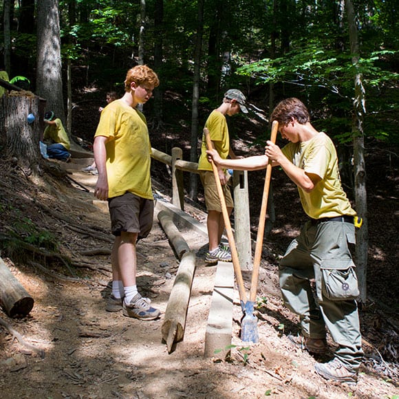 Boyd Rollins, Zach Conover and Luke Barrick dig into some hard work on a Ganier Ridge trail project during the Junior Ranger program at Radnor Lake State Natural Area in Nashville. Photograph by Robin Conover.