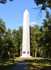 A monument marks the site of the Battle of Kings Mountain in South Carolina. Below, re-enactors at Sycamore Shoals State Park re-create the muster of the Overmountian Men who traveled to Kings Mountain. Many think of South Carolina as being far east of Tennessee, but some of the Overmountain Men had to march west to battle the British.