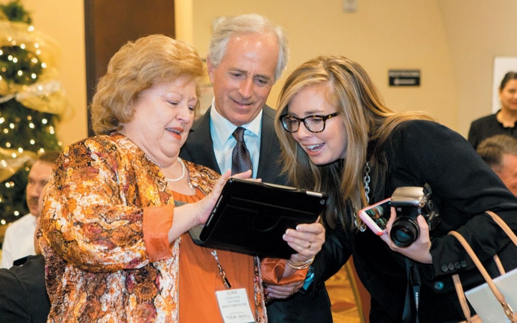 Middle Tennessee Electric Membership Corporation board member Gloria O’Steen, left, shares a fourth-grade photograph of Sen. Bob Corker with the senator and his field representative, Carlie Cruse.