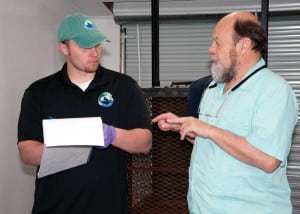 Curator Cody Blair confers with vet Ed Ramsey on care for bears at the rescue.