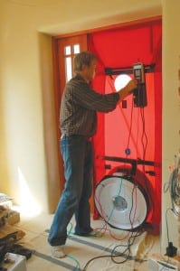 A blower-door test during a home energy audit can help identify sources of air leakage. Photo Credit: Tõnu Mauring