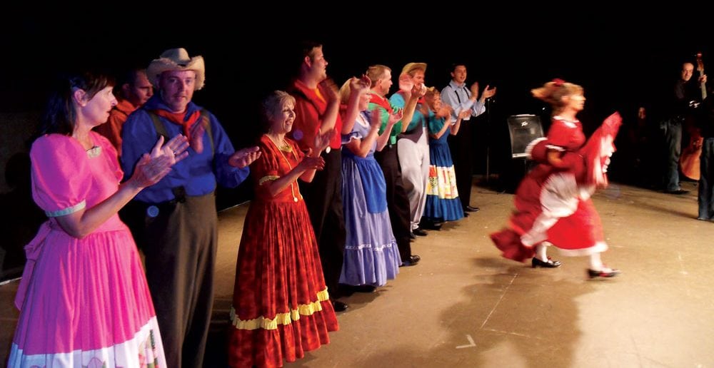 Cripple Creek Cloggers in their traditional costumes greet the audience.