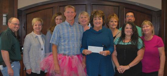 Bedford Cancer Foundation representatives receive a check for the "real Men Wear Pink" fundraiser from Shelbyville Times-Gazette Publisher High Jones.
