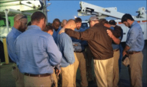 Chris Jones, CEO of Middle Tennessee Electric Membership Corporation, prays with a group of linemen before they depart to assist with Hurricane Matthew recovery efforts.